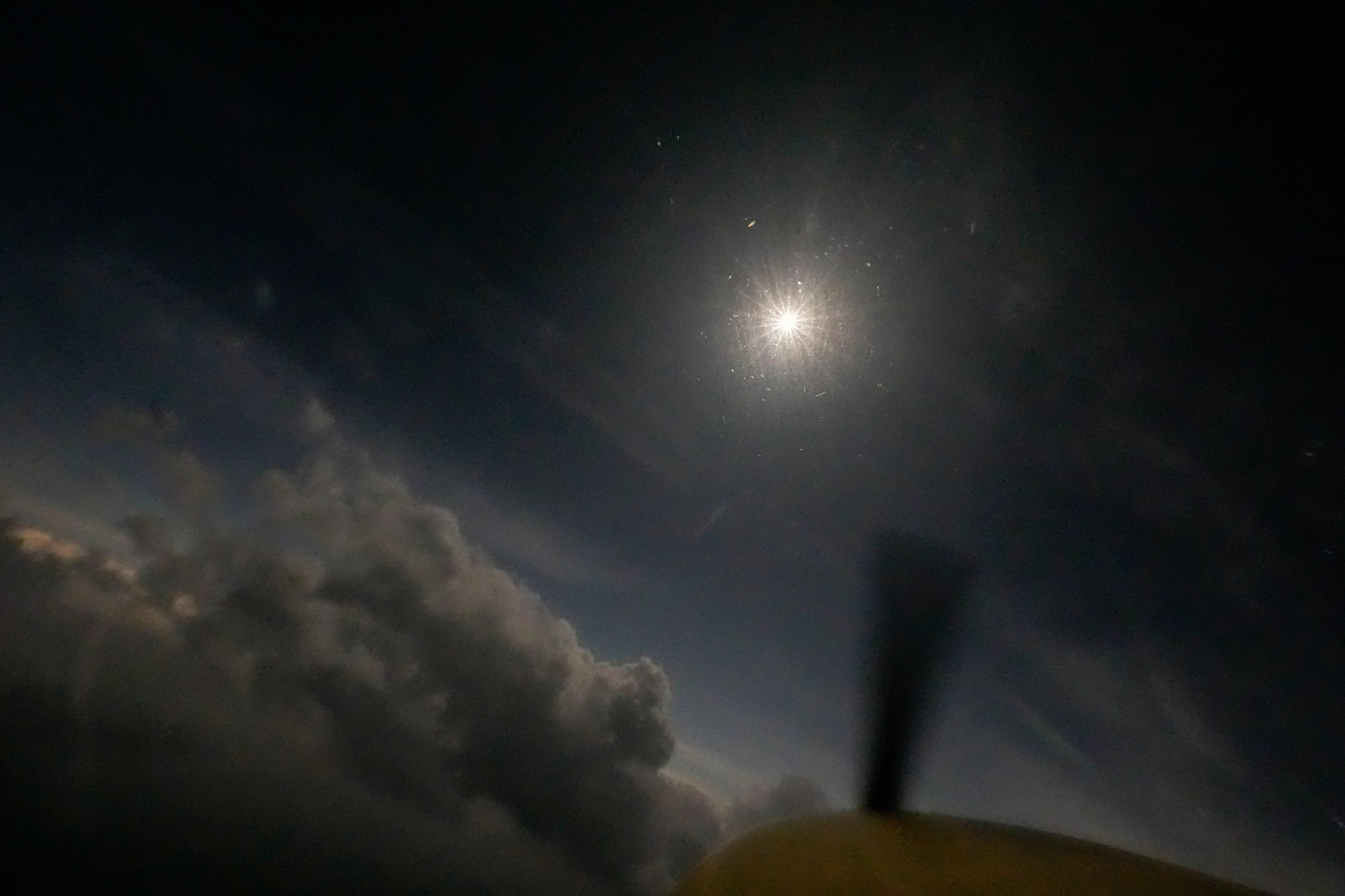 A nighttime sky unfolds in the afternoon as the moon partially covers the sun during a total solar eclipse, as seen from the air in a Cessna 172 aircraft, at about 5,000 ft., over in Arkadelphia, Ark., within the path of totality