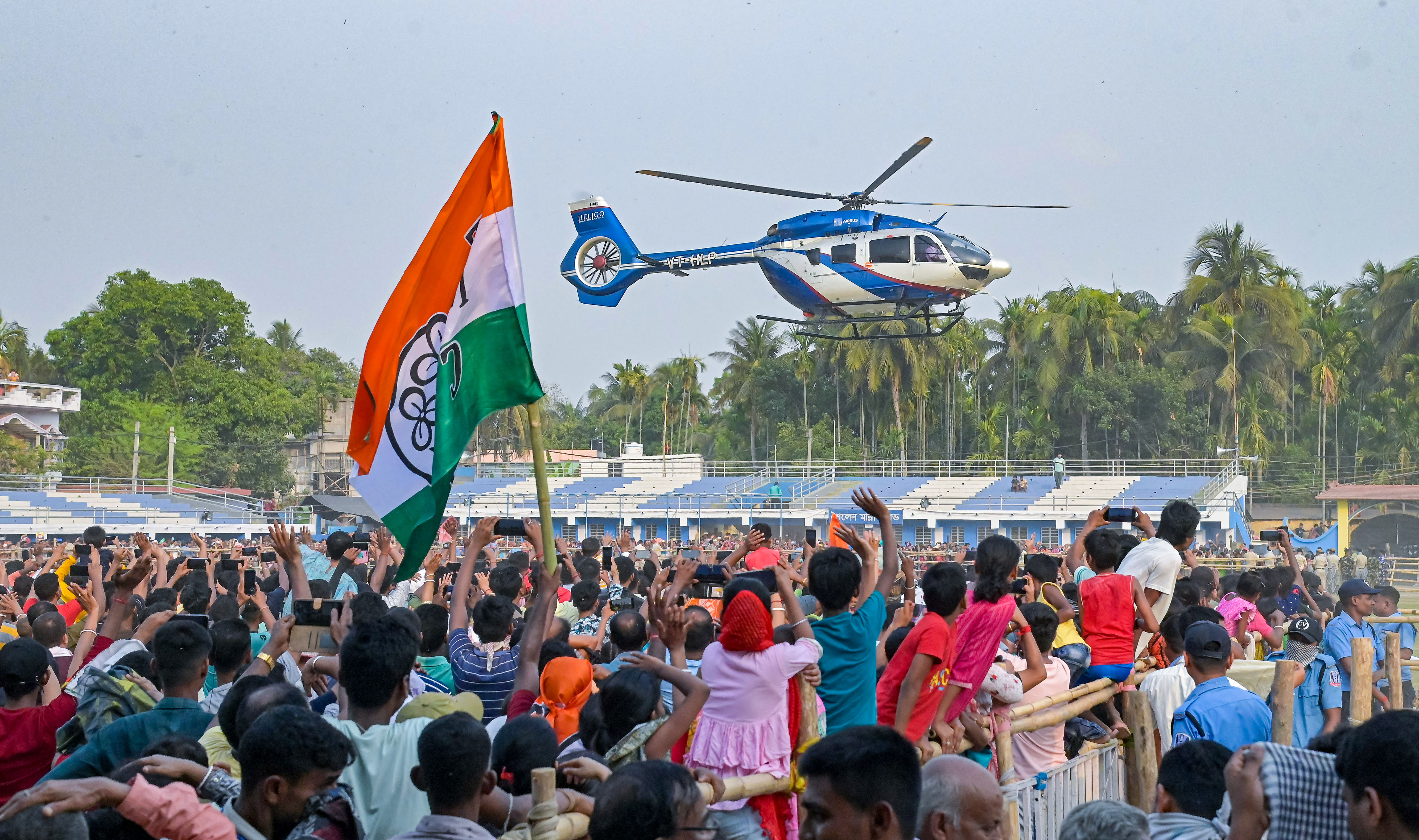 TMC supporters wave at chief minister Mamata Banerjee's helicopter as she leaves after addressing a public meeting at Birnagar in Nadia district, on Saturday.