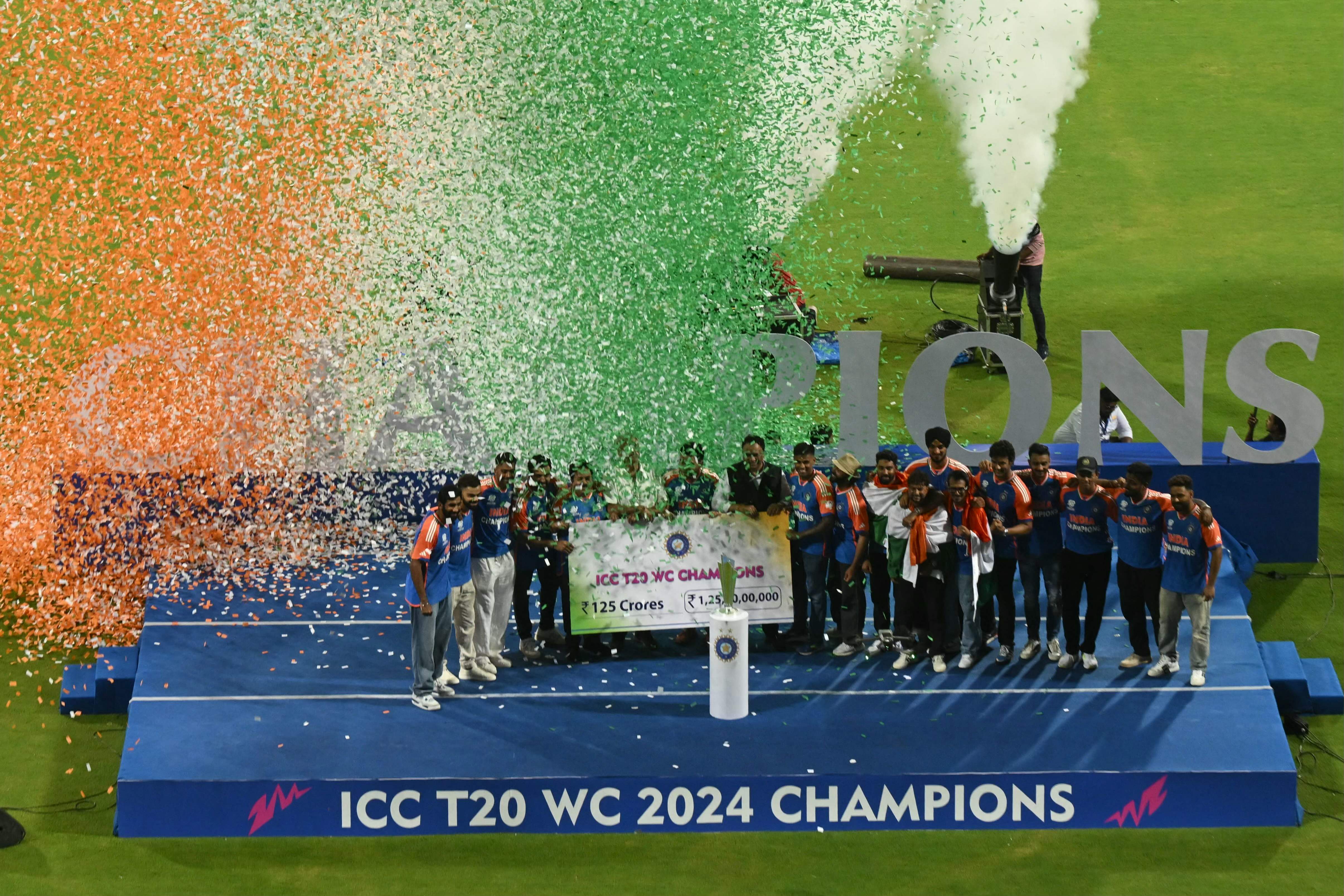 Members of the Indian cricket team stand on a podium during a ceremony at the Wankhede stadium in Mumbai on July 4, 2024, to celebrate India's championship in the ICC men's Twenty20 World Cup 2024 held in Barbados. (Photo by AFP)